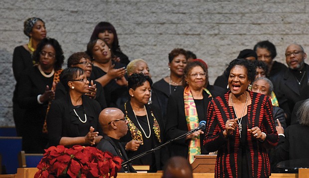 The Rev. Delores McQuinn, right, a member of the Virginia House of Delegates, sings with the choir during the service.
