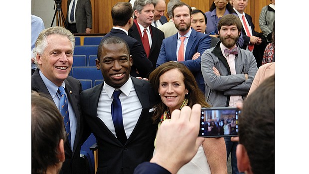 Newly installed Richmond Mayor Levar Stoney smiles for a
photo with his friend and mentor, Gov. Terry McAuliffe, and First Lady
Dorothy McAuliffe after last Saturday’s swearing-in ceremony at City
Hall.