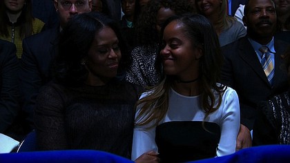 President Obama makes his final presidential speech to the nation on January 10, 2017 in Chicago, Illinois. First Lady Michelle Obama and their daughter smile listening to her husband's speech.