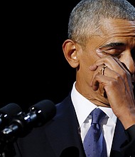 President Obama wipes away tears during an emotional moment in his address