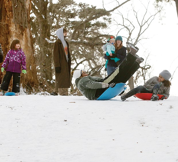 Snow day!
Harmony Ellis, right, enjoys Jazz Booker’s attempt to get moving down the slopes in Bryan Park on Monday as the youngsters and many families took to the outdoors to play in the snow. The much-anticipated snowfall was accompanied with below-freezing temperatures, closing area public schools for three days. Please see more photos, A2.