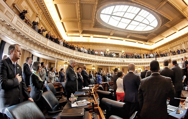 Lawmakers return to Richmond // Left, members of the Virginia House of Delegates recite the Pledge of Allegiance at the state Capitol on Wednesday on the opening day of the new General Assembly session. The 100-member House and 40-member Senate will amend the state budget and deal with more than 2,000 bills during the 46-day session. 
 