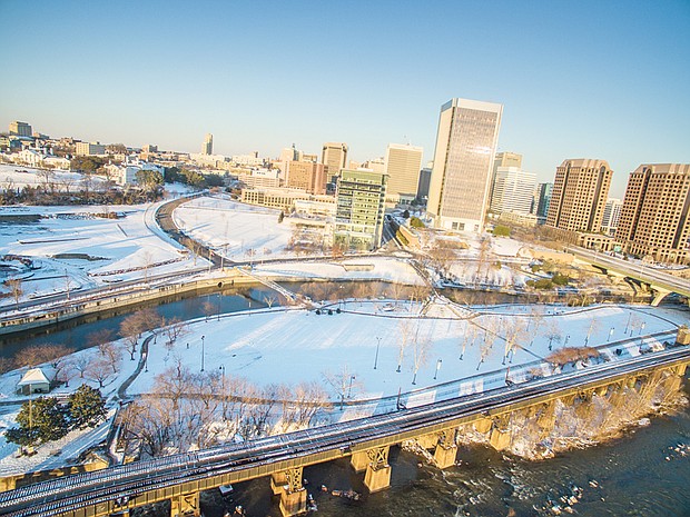 Ribbons of clear roads and tracks cut through the snowy landscape in this drone’s view of Downtown in Sunday’s sunshine.