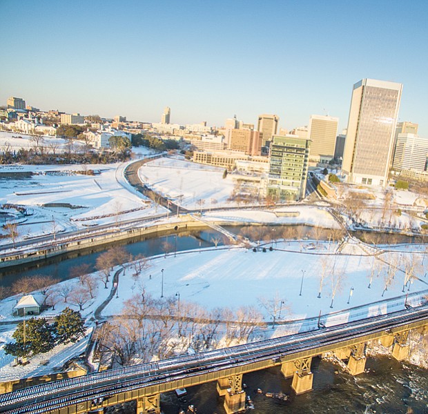 Ribbons of clear roads and tracks cut through the snowy landscape in this drone’s view of Downtown in Sunday’s sunshine.
