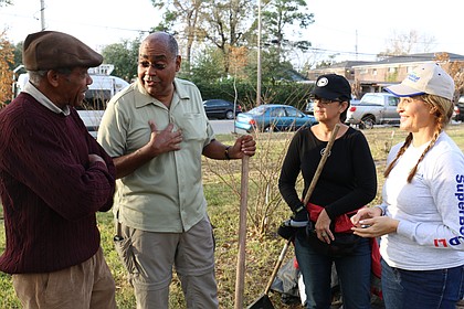 Harris County Commissioner Rodney Ellis, second from left, discusses future upkeep of the Evergreen Cemetery with Woodrow W. Jones with Project RESPECT, the commissioner’s wife, Licia Green-Ellis, and Gaynell Drexler, Houston Habitat for Humanity’s chairwoman of the board.