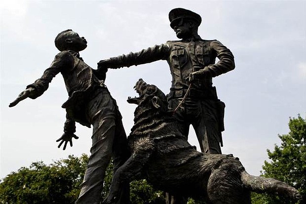 A young protester confronted by a police officer and a snarling police dog is depicted in a sculpture in Kelly Ingram Park in Birmingham, AL (Butch Dill/AP)