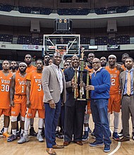 
The Virginia State University Trojans show off their trophy following their 74-59 win over Virginia Union University in last Sunday’s Freedom Classic at the Richmond Coliseum. Holding the trophy are, from left, Richmond Mayor Levar M. Stoney, VSU basketball Coach Lonnie Blow and VSU President Makola M. Abdullah. 