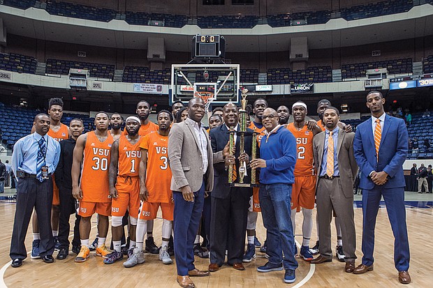 
The Virginia State University Trojans show off their trophy following their 74-59 win over Virginia Union University in last Sunday’s Freedom Classic at the Richmond Coliseum. Holding the trophy are, from left, Richmond Mayor Levar M. Stoney, VSU basketball Coach Lonnie Blow and VSU President Makola M. Abdullah. 