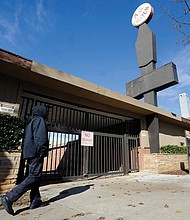 A woman walks past the abandoned A.G. Gaston Motel in Birmingham, Ala., that was home to a strategy “war room” for Dr. Martin Luther King Jr. in the 1960s. The hotel will be renovated as part of a civil rights monument that will join the National Park Service under a proclamation signed Jan. 12 by President Obama.