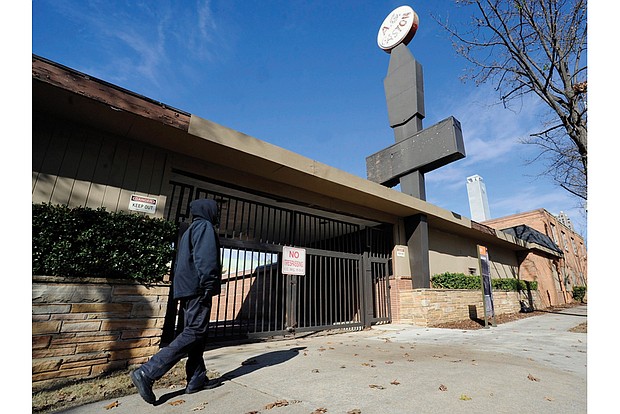 A woman walks past the abandoned A.G. Gaston Motel in Birmingham, Ala., that was home to a strategy “war room” for Dr. Martin Luther King Jr. in the 1960s. The hotel will be renovated as part of a civil rights monument that will join the National Park Service under a proclamation signed Jan. 12 by President Obama.