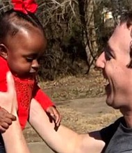 Facebook CEO Mark Zuckerberg with child