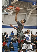 George Wythe High School’s Darrell Purdie puts up a shot against L.C. Bird High School’s Johquin Wiley during a game Jan. 4. The Wythe Bulldogs won the game and are now 7-3.