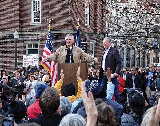 Supporting Obamacare //
Gov. Terry McAuliffe, left, and U.S. Sen. Tim Kaine rally Virginians against Republican plans to repeal the Affordable Care Act, or Obamacare, during an event last Sunday in Capital Square. 
Nearly 1,000 people attended the event, which was joined by several other state, local and federal elected officials, including Lt. Gov. Ralph S. Northam, Rep. A. Donald McEachin of Richmond and Rep. Robert C. “Bobby” Scott of Newport News.
The rally at the Bell Tower was one of dozens held across the United States last weekend to coalesce support for saving the health insurance program. Republicans have made repeal of the Affordable Care Act a priority with the election of President-elect Donald Trump.
More than 400,000 Virginians and 20 million Americans have enrolled in health insurance plans since the law was passed in 2010.
Sen. Kaine, who ran unsuccessfully as the Democratic vice presidential candidate, is encouraging Virginians to share how the ACA has helped them or a family member, or to offer suggestions for improvement. Stories may be submitted by visiting www.kaine.senate.gov/acastory.
