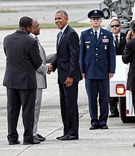 President Obama is greeted by Tyrone Nelson, chairman of the Henrico County Board of Supervisors, left, and Richmond Mayor Dwight C. Jones upon arrival at Richmond International Airport in September 2016. The president stopped in Richmond on his way to Fort Lee in Petersburg for a town hall with military families. 