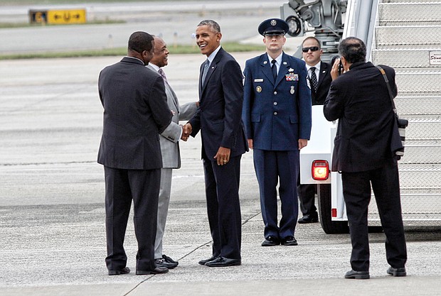 President Obama is greeted by Tyrone Nelson, chairman of the Henrico County Board of Supervisors, left, and Richmond Mayor Dwight C. Jones upon arrival at Richmond International Airport in September 2016. The president stopped in Richmond on his way to Fort Lee in Petersburg for a town hall with military families. 