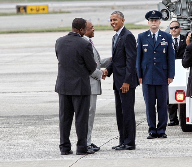 President Obama is greeted by Tyrone Nelson, chairman of the Henrico County Board of Supervisors, left, and Richmond Mayor Dwight C. Jones upon arrival at Richmond International Airport in September 2016. The president stopped in Richmond on his way to Fort Lee in Petersburg for a town hall with military families. 