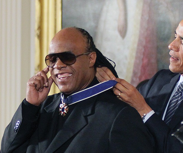 
President Obama awards singer Stevie Wonder the Presidential Medal of Freedom during a White House ceremony in November 2014.