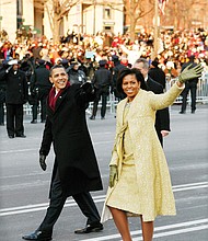 newly sworn-in President Obama and his wife walk down Pennsylvania Avenue to the cheers of the crowd during his Inaugural Parade in 2009.
