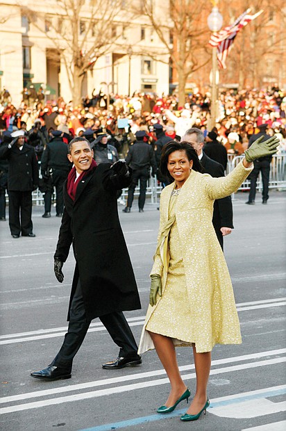 newly sworn-in President Obama and his wife walk down Pennsylvania Avenue to the cheers of the crowd during his Inaugural Parade in 2009.
