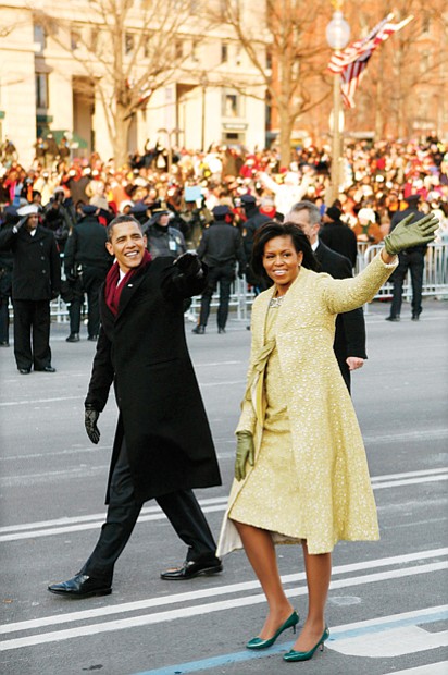 newly sworn-in President Obama and his wife walk down Pennsylvania Avenue to the cheers of the crowd during his Inaugural Parade in 2009.
