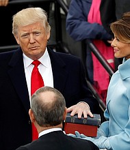 President Donald Trump is sworn in last Friday by Chief Justice John Roberts of the U.S. Supreme Court, with his wife, Melania, holding the Bible and their son, Barron, nearby.