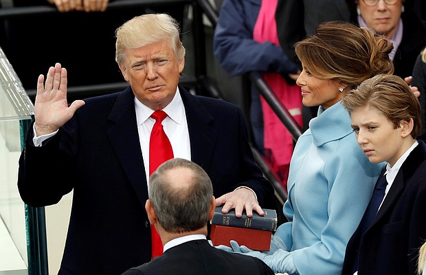 President Donald Trump is sworn in last Friday by Chief Justice John Roberts of the U.S. Supreme Court, with his wife, Melania, holding the Bible and their son, Barron, nearby.