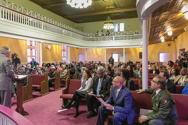 $400,000 for Jackson Ward church 
Gov. Terry McAuliffe, at podium, celebrates the award of a $400,000 federal preservation grant to Third Street Bethel A.M.E. Church last Friday at a gathering inside the church’s 160-year-old sanctuary at 3rd and Jackson streets. Among those taking part in the announcement are (front row, from left): Virginia First Lady Dorothy McAuliffe; Congressman A. Donald McEachin; the Rev. Reuben J. Boyd Jr., the church’s pastor; and David Ruth, superintendent of the Richmond National Battlefield Park. The church is one of 39 historic African-American sites across the country to receive grants from the National Park Service through its new effort to protect significant, but often little-known civil rights sites. The church, registered as a national historic landmark since 1978, has long served as a community bastion in the fight for equality. The Virginia Department of Historic Resources is to administer the grant that will be used to replace the roof and take care of other elements of the building that dates to 1857, four years before the start of the Civil War. 