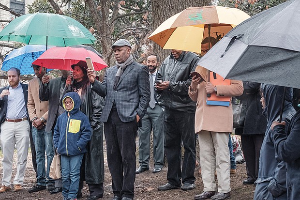 About 60 people hold a vigil and protest at the Bell Tower in Capitol Square in Downtown last Friday as President Trump was taking the oath of office in Washington.