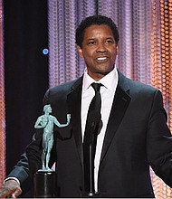 Actor Denzel Washington accepts Outstanding Performance by a Male Actor in a Leading Role for 'Fences' onstage during the 23rd Annual Screen Actors Guild Awards show at The Shrine Auditorium on January 29, 2017 in Los Angeles, California. / AFP / Robyn BECK 