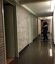 Stagnant water can be seen in one of the UH dorm hallways Sunday evening.