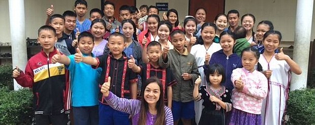 Tutu Bee (front center), the director for Asia's Hope Thailand, lives with 24 children in the Doi Saket 4 orphanage home, the home built with Jerod Cherry's donation. Courtesy of Asia's Hope