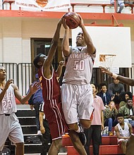 Manu Moss fights off a defender and powers to the basket in leading Thomas Jefferson to a 68-63 victory over Petersburg last week.