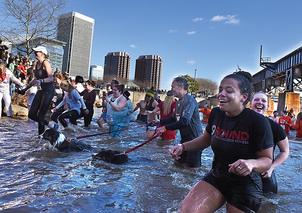 People  leave the frigid water of the James River last Saturday afternoon after the 3rd Annual Shiver in the River, a benefit for Keep Virginia Beautiful. Location: The shoreline near Brown’s Island. This view shows hearty participants headed back to land to dry off. The event, based at Historic Tredegar, also included a cleanup of litter along the riverfront and a 5K walk and run
People  leave the frigid water of the James River last Saturday afternoon after the 3rd Annual Shiver in the River, a benefit for Keep Virginia Beautiful. Location: The shoreline near Brown’s Island. This view shows hearty participants headed back to land to dry off. The event, based at Historic Tredegar, also included a cleanup of litter along the riverfront and a 5K walk and run.