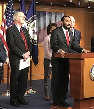 Rep. Al Green speaking at the press conference with his colleagues (from left to right) Rep. Vicente Gonzalez, Rep. Bill Foster, Financial Services Committee Ranking Member Rep. Maxine Waters, Rep. Brad Sherman, and Minority Leader Rep. Nancy Pelosi.