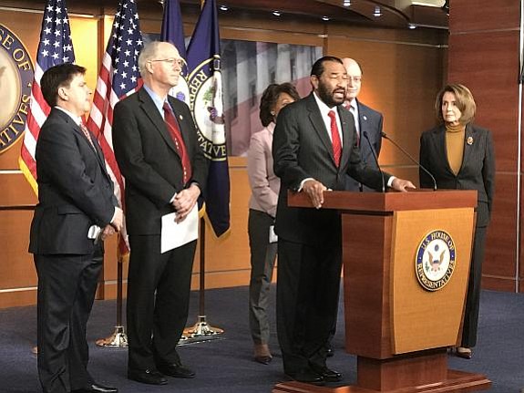 Rep. Al Green speaking at the press conference with his colleagues (from left to right) Rep. Vicente Gonzalez, Rep. Bill Foster, Financial Services Committee Ranking Member Rep. Maxine Waters, Rep. Brad Sherman, and Minority Leader Rep. Nancy Pelosi.