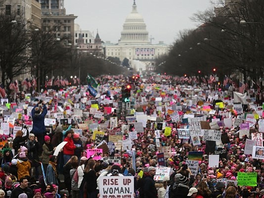 Protesters walk during the Women's March on Washington, with the U.S. Capitol in the background, on January 21, 2017 in Washington, DC. (Photo by Mario Tama/Getty Images)
