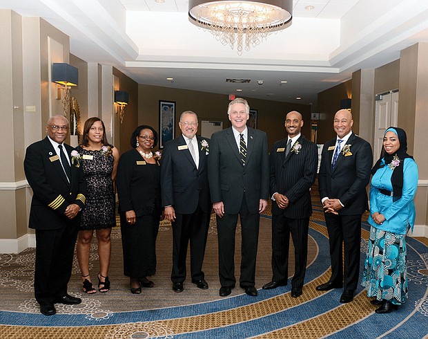 2017 Strong Men & Women honored //Seven high achievers were honored at the 2017 Strong Men & Women in Virginia History program Feb. 1 at a Downtown hotel. 
Gov. Terry McAuliffe, center, celebrates with the honorees during the annual event that Dominion Resources and the Library of Virginia co-sponsor to honor African-American standouts. 
From left, the honorees are: Capt. William E. “Bill” Bailey of Accomack, a decorated military pilot; Virginia Court of Appeals Judge Mary Janipher Bennett Malveaux of Henrico County, the court’s first African-American female member; Dr. Margaret Ellen Mayo Tolbert of Suffolk, influential biochemist and author; and Charles Johnson III, who accepted the award on behalf of his late grandfather, sociologist Charles Spurgeon Johnson of Bristol, the first African-American president of Fisk University.
Also, Optician David Lambert, representing his late father, Dr. Benjamin J. Lambert III of Richmond, a former state senator and optometrist who played a major role in civic affairs; Jeffrey Moten, who honored the memory of his late wife, Stephanie Therese Rochon-Moten of Richmond, award-winning television reporter and news anchor; and Zakia Al-Amin, who stood in for her grandfather, pioneering Virginia pharmacist Leonard “Doc” Muse of Arlington, who owned and operated Green Valley Pharmacy for 65 years. 