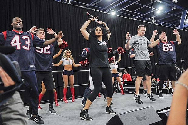 Jordin Sparks helping kids exercise at NFL Play 60 Kids' Day at the NFL Experience/photo by Vicky Pink 