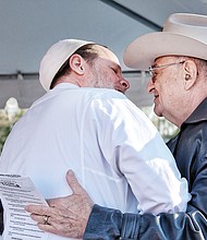 Imam Ammar Amonette of the Islamic
Center of Virginia, left, greets Jay
M. Ipson, co-founder of the Virginia
Holocaust Museum in Richmond
during the rally.