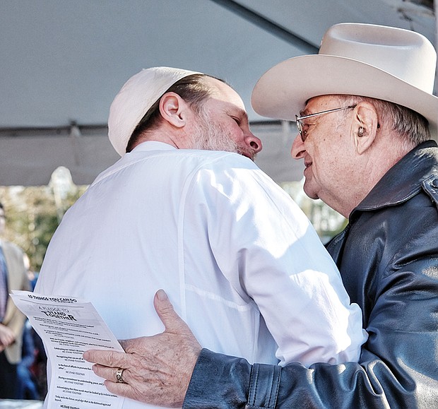 Imam Ammar Amonette of the Islamic
Center of Virginia, left, greets Jay
M. Ipson, co-founder of the Virginia
Holocaust Museum in Richmond
during the rally.