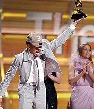 Chance the Rapper exuberantly accepts the Grammy for Best New Artist, one of two he won.