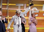 Chance the Rapper exuberantly accepts the Grammy for Best New Artist, one of two he won.