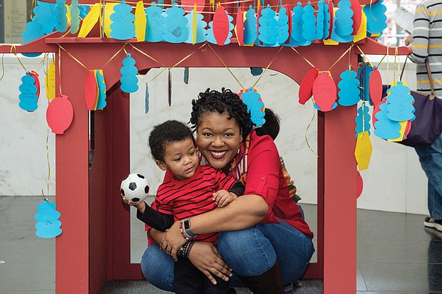 Under a pagoda //
Xavier Judon, 2, and his mother, Melissa, strike a playful pose under a handcrafted pagoda set up for last Saturday’s ChinaFest! Year of the Fire Rooster. The family-oriented event took place at the Virginia Museum of Fine Arts. Please see more photos, B2.