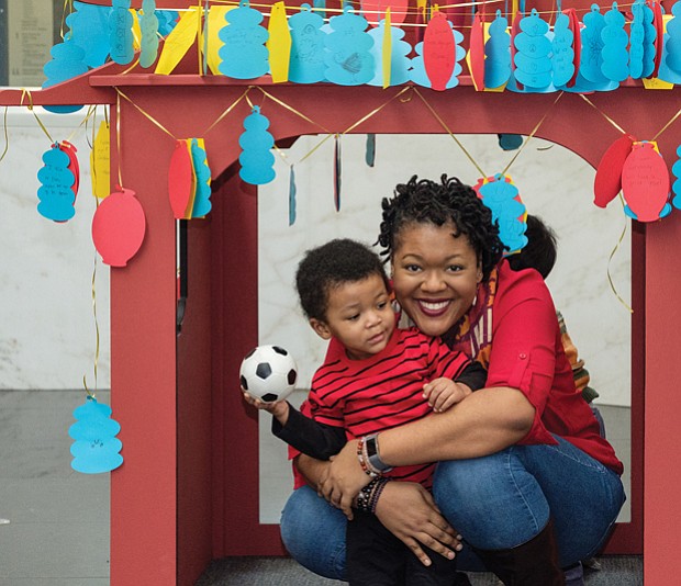Under a pagoda //
Xavier Judon, 2, and his mother, Melissa, strike a playful pose under a handcrafted pagoda set up for last Saturday’s ChinaFest! Year of the Fire Rooster. The family-oriented event took place at the Virginia Museum of Fine Arts. Please see more photos, B2.