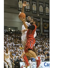 
Virginia Commonwealth University’s Moe Alie-Cox goes up to block a shot from Jack Gibbs of Davidson College during last Saturday’s game at the Siegel Center. The Rams beat Davidson 74-60.