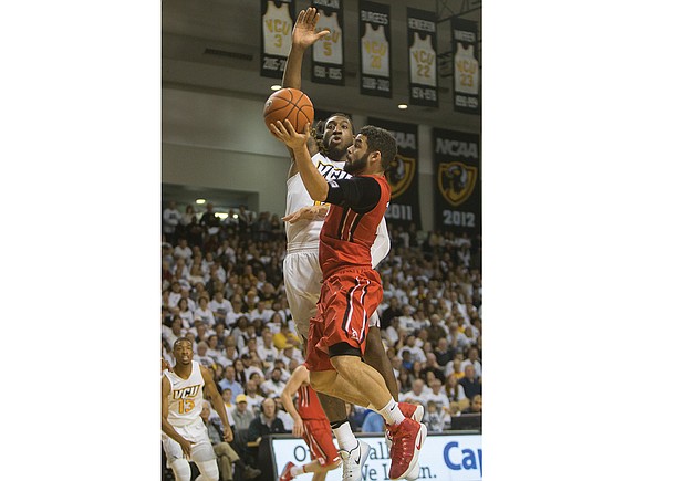 
Virginia Commonwealth University’s Moe Alie-Cox goes up to block a shot from Jack Gibbs of Davidson College during last Saturday’s game at the Siegel Center. The Rams beat Davidson 74-60.