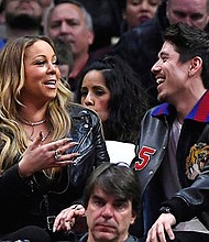 Mariah Carey and backup dancer Bryan Tanaka