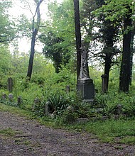 These May 2016 photos show the impact of cleanup efforts at historic Evergreen Cemetery. The above photo shows one plot before volunteers with the Maggie Walker High School Class of 1967 led by Marvin Harris went to work.