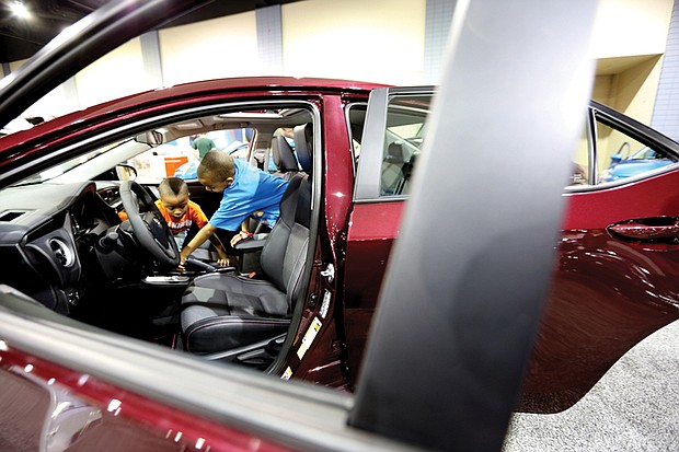 Ready to ride //
Landon Johnson, 4, left, gets a few pointers about choosing the right ride from his 10-year-old brother, Elijah, as they check out the interior of a sporty 2017 Toyota Corolla XSE last Saturday at the Virginia International Auto Show. The event that features hundreds of vehicles from various manufacturers, test drives and family fun was held at the Greater Richmond Convention Center in Downtown.