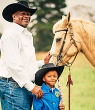 Prairie View Trail Riders Trail Boss Myrtis Dightman, Jr. with his grandson/credit KATYA HORNER